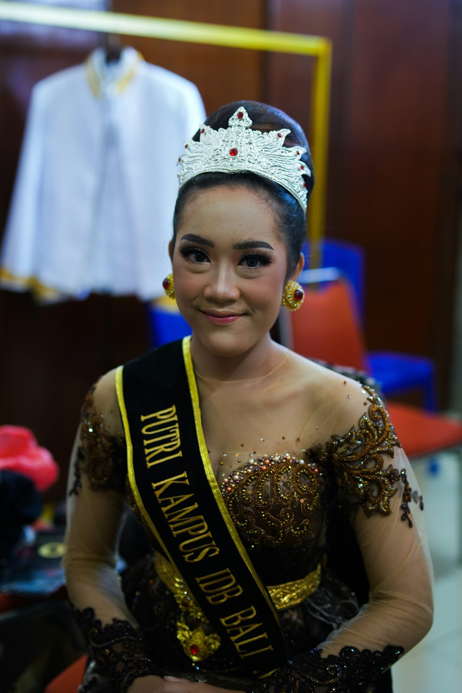 a woman wearing a tiara and smiling for the camera